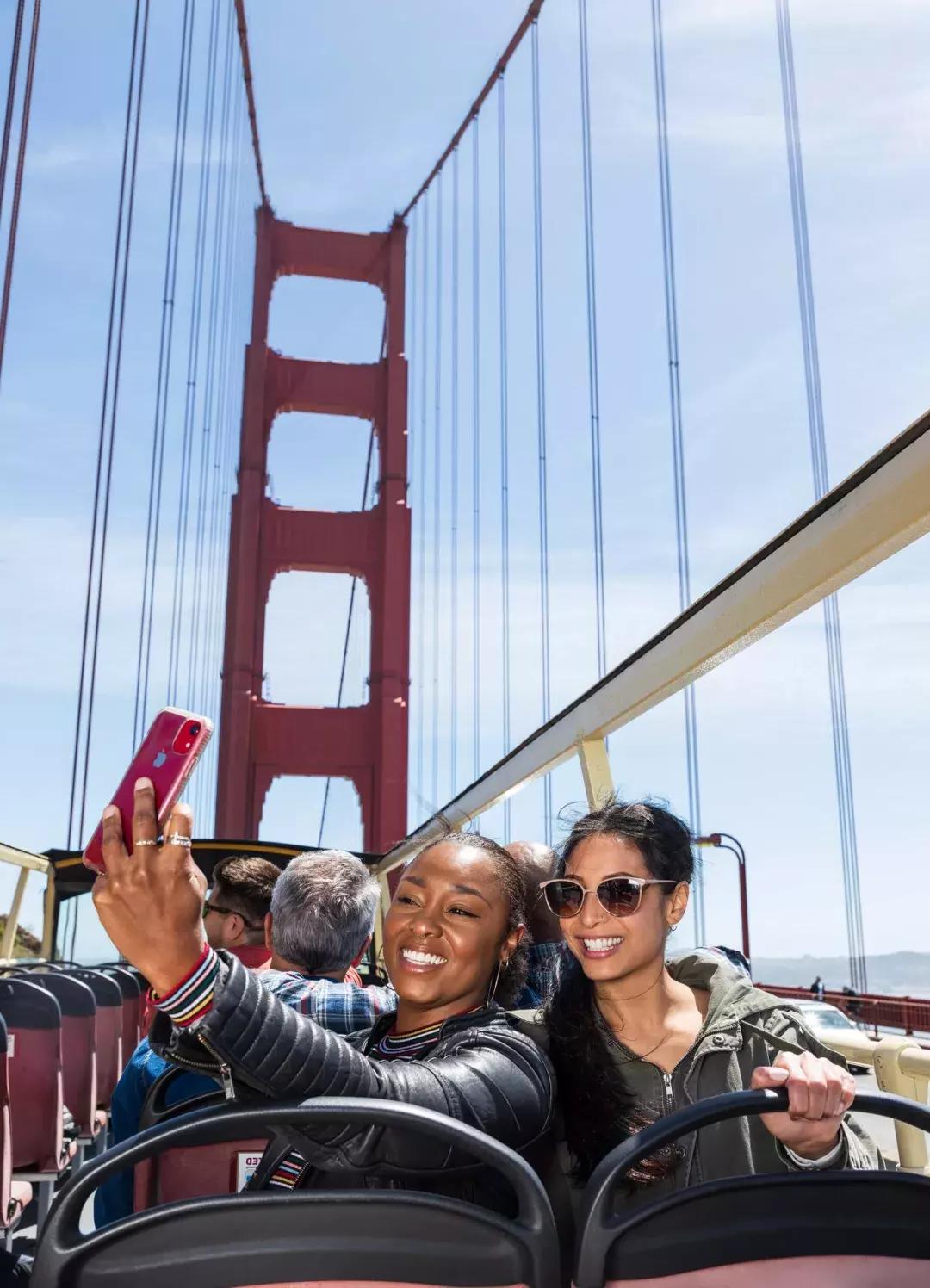 Friends taking selfies on the Golden Gate Bridge